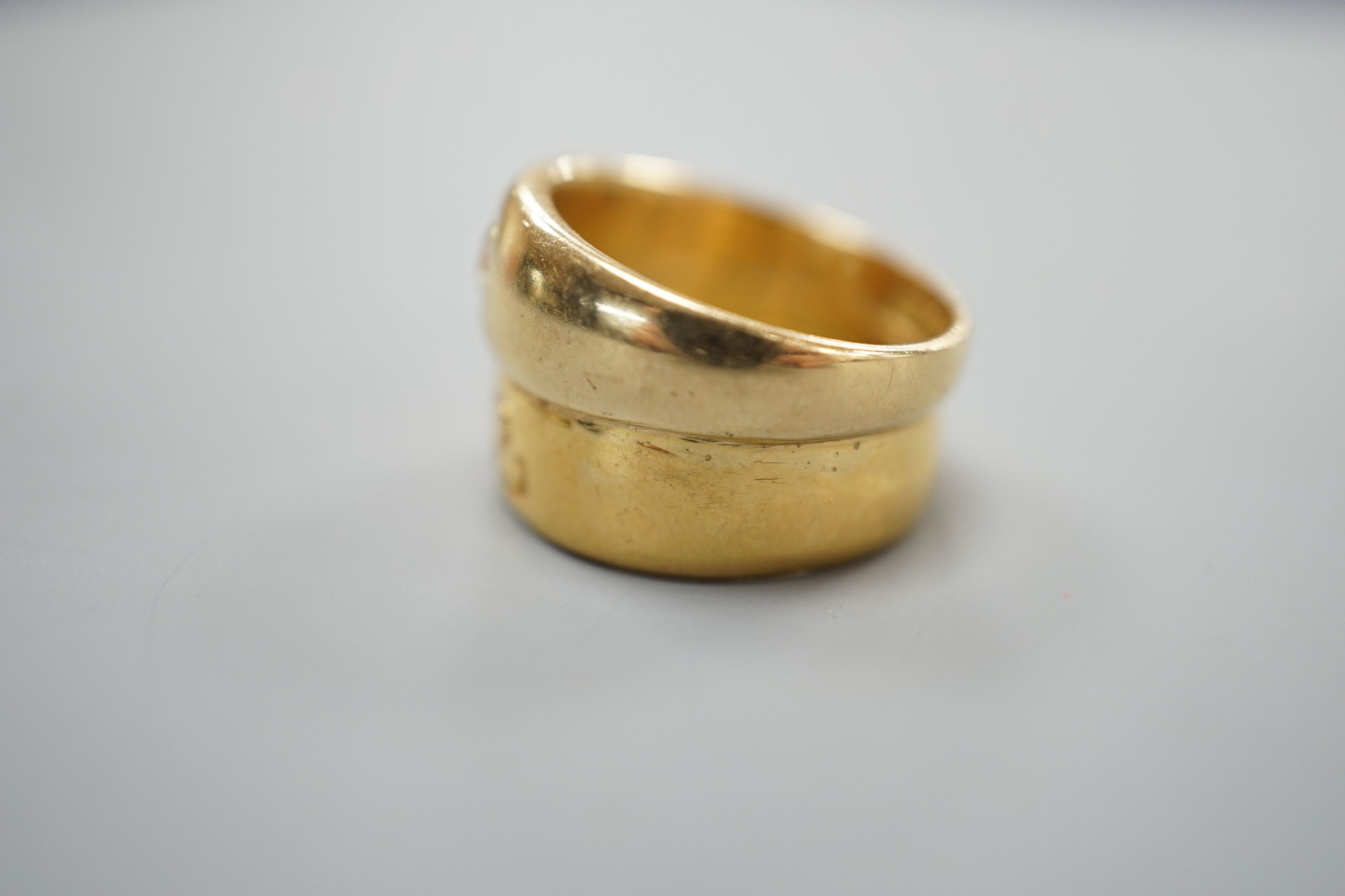 A 22ct gold band, welded to an 18ct gold and diamond set band, size L, gross weight 8.3 grams.